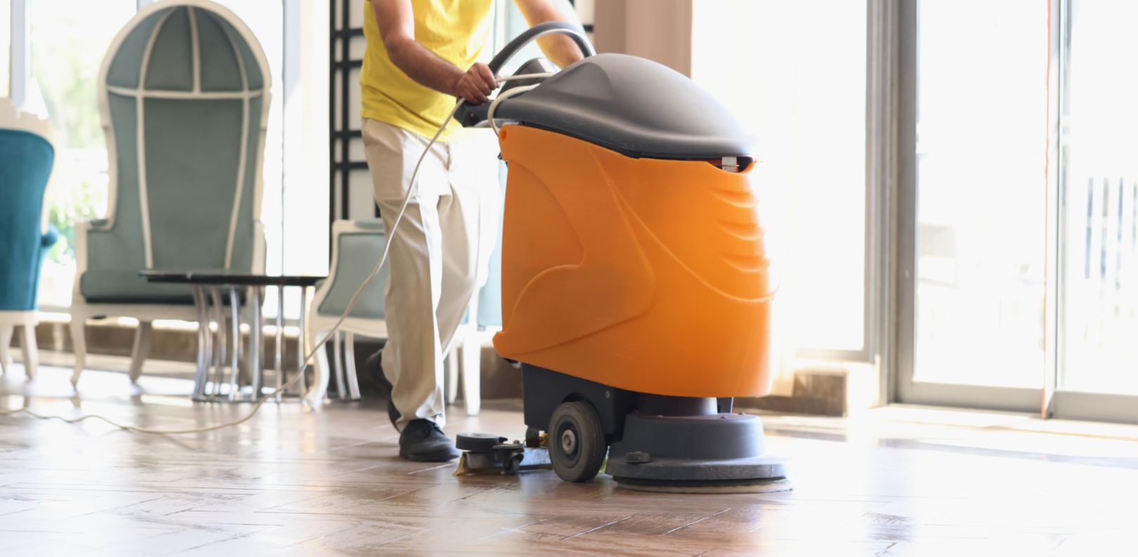 man is cleaning hotel lobby with industrial vacuum cleaner 1